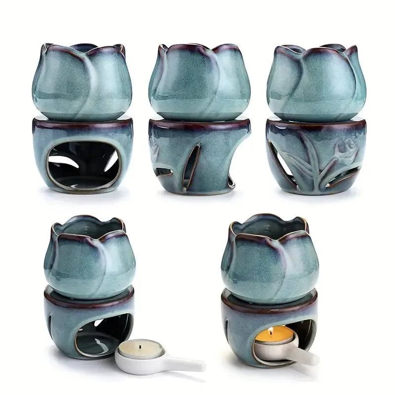 Set of six blue ceramic wax warmers with a white candle on a white background