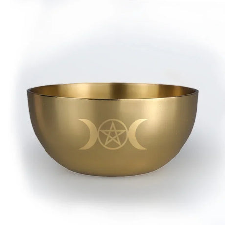 Gold bowl with engraved symbol on a white background