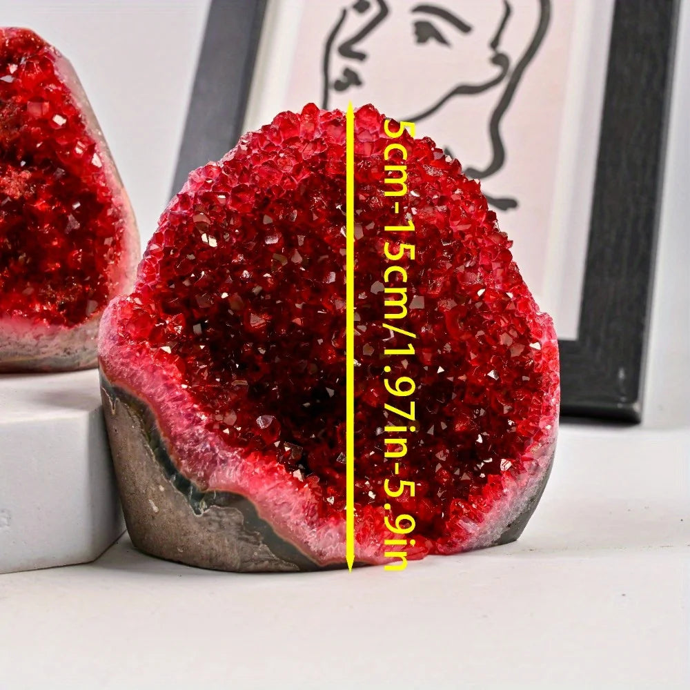 Red crystal geode with measurement text on a white surface