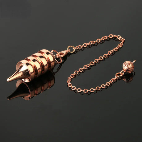 Rose gold spiral pendant on a chain against a black background