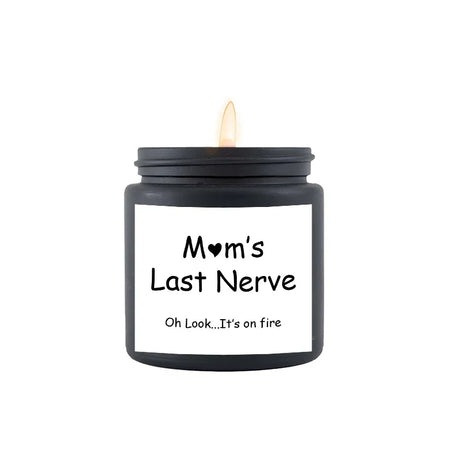 Black candle with a white label reading 'Mom's Last Nerve' on a white background