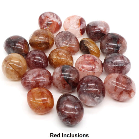 Collection of multicolored stones with red inclusions on a white background
