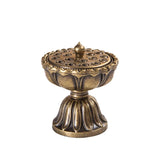 Bronze incense burner with intricate design on a white background