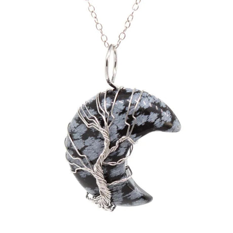 Black and white striped pendant on a silver chain against a white background