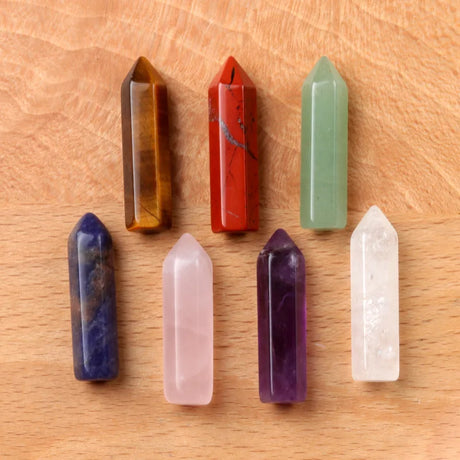 Set of colorful crystal points on a wooden surface