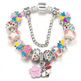 Colorful charm bracelet with floral and butterfly designs on a white background