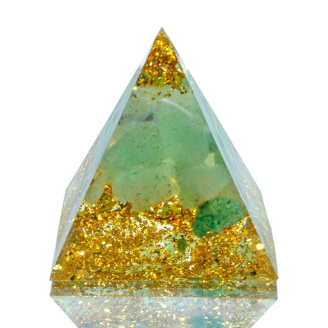 Triangular crystal with gold and green inclusions on a white background