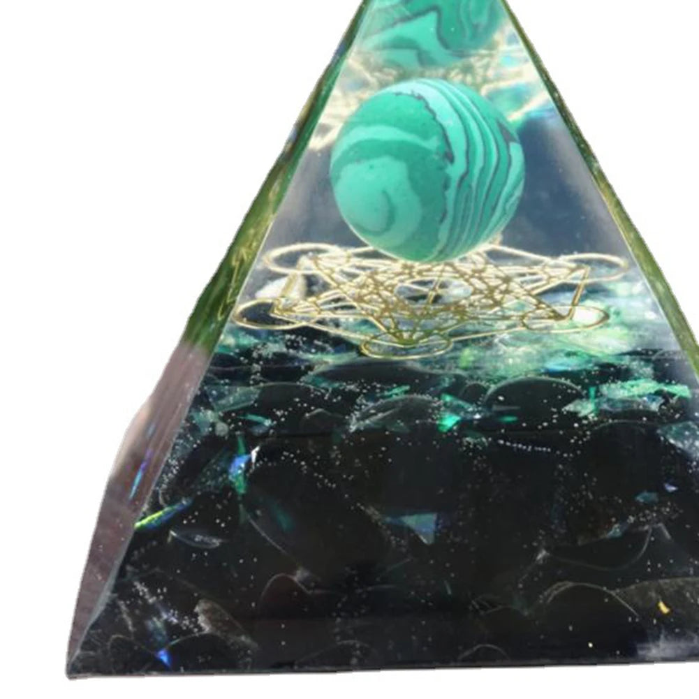 Triangular pyramid with a green marbled ball and gold wire on a white background