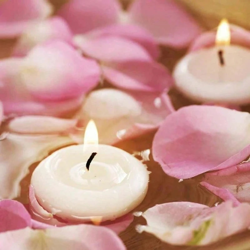 Floating candles and pink rose petals on water