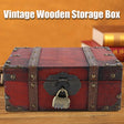 Vintage wooden storage box with a lock on a wooden surface, with an orange background.