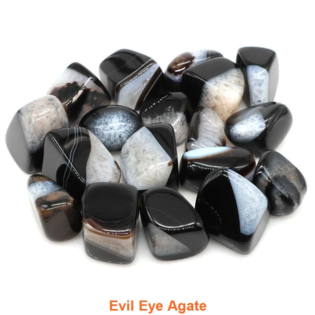 Collection of black and white agate stones labeled 'Evil Eye Agate' on a white background
