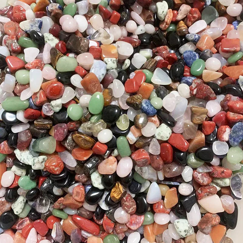 Assorted small pebbles in various colors on a white background