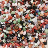 Assorted small pebbles in various colors on a white background