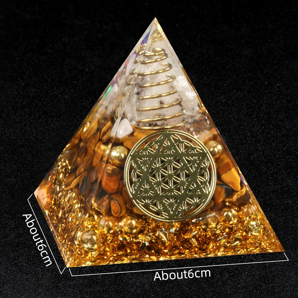 Pyramid-shaped crystal with gold coin and star design on a black background