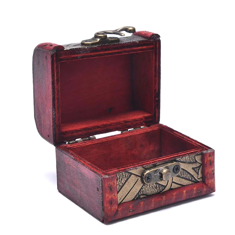 Open red jewelry box with decorative elements on a white background