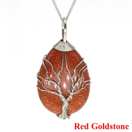 Red goldstone pendant with silver wire wrapping on a white background