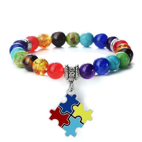 Colorful beaded bracelet with a puzzle piece charm on a white background