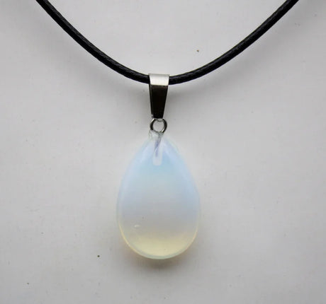 Teardrop-shaped pendant on a black cord against a white background