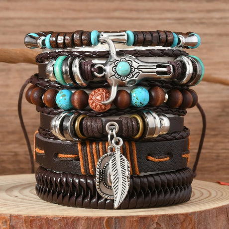 Stack of leather and beaded bracelets with metal charms on a wooden surface