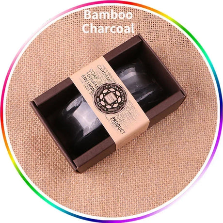 Bamboo charcoal soap in a box on a textured fabric background