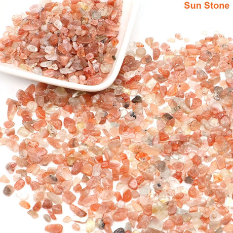 Sun stone pebbles with a white scoop on a white background