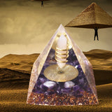 Pyramid-shaped crystal with inner design, set against a desert landscape with pyramids.