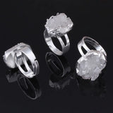 Three silver rings with crystal-like designs on a black background