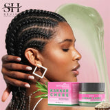 Woman with braided hair holding a container of Sevich Karkar Chebe Grease against a pink background