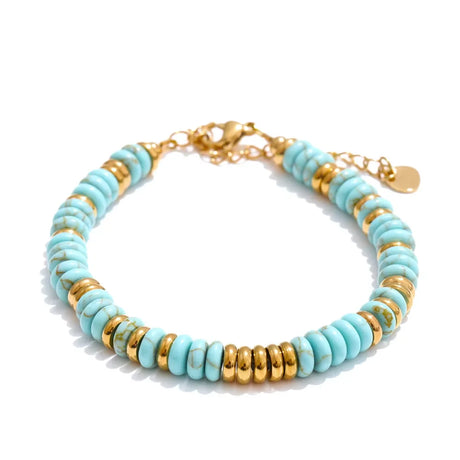 Turquoise and gold beaded bracelet on a white background