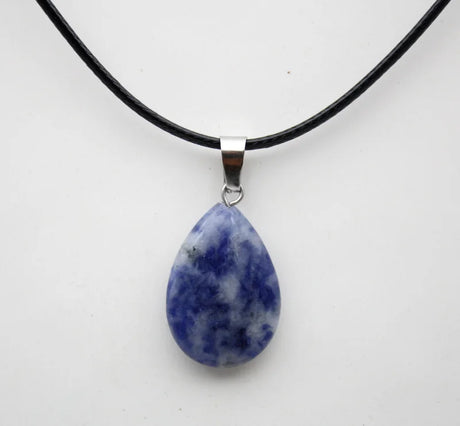 Teardrop-shaped blue stone pendant on a black cord against a white background