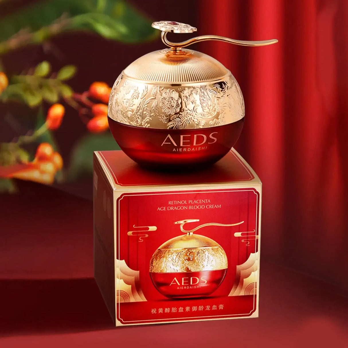Red and gold AEDS skincare product with decorative box on a red background