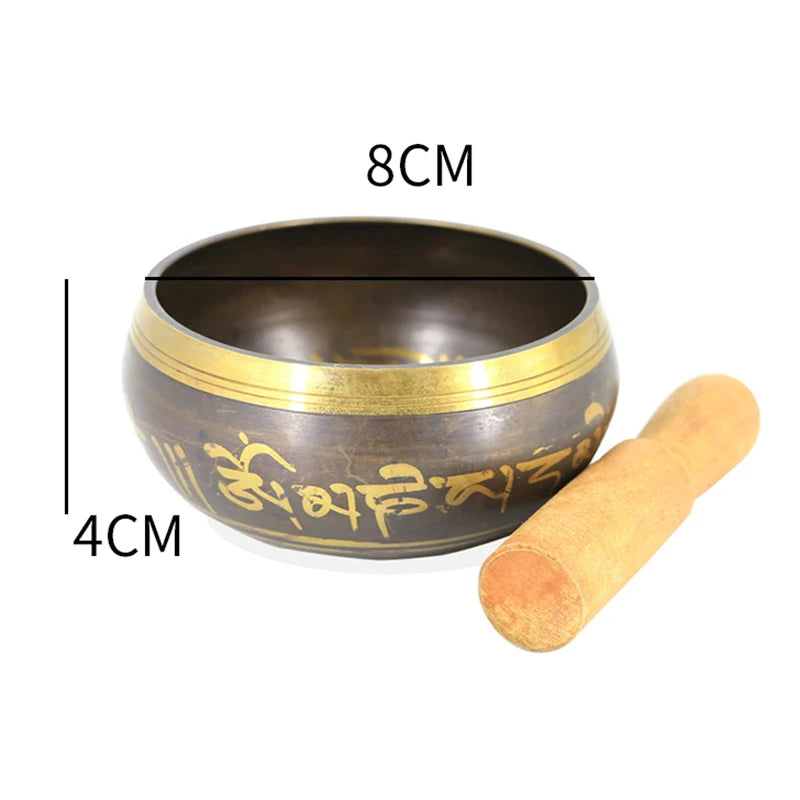 Tibetan singing bowl with measurements and wooden striker on a white background