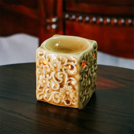Decorative ceramic container with intricate patterns on a wooden surface