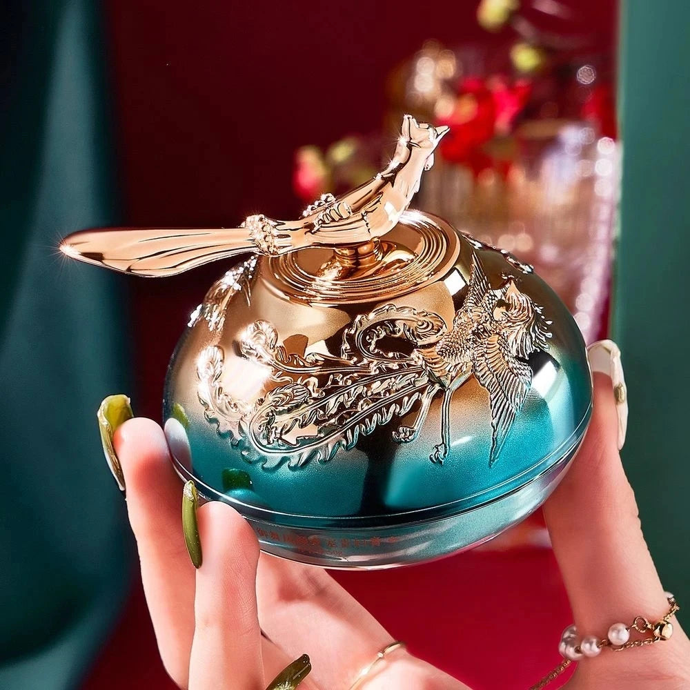 Decorative item with intricate design held by a hand against a blurred background