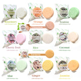 Collection of solid shampoo bars with packaging labeled for different scents on a white background.