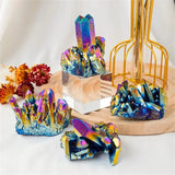 Colorful crystal formations on a wooden stand with a white background