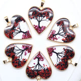 Heart-shaped pendants with floral design on a white background