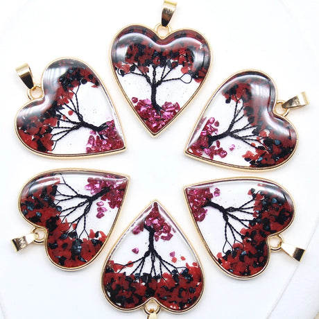 Heart-shaped pendants with floral design on a white background