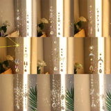 Decorative hanging crystal with floral and leaf elements in a collage format.