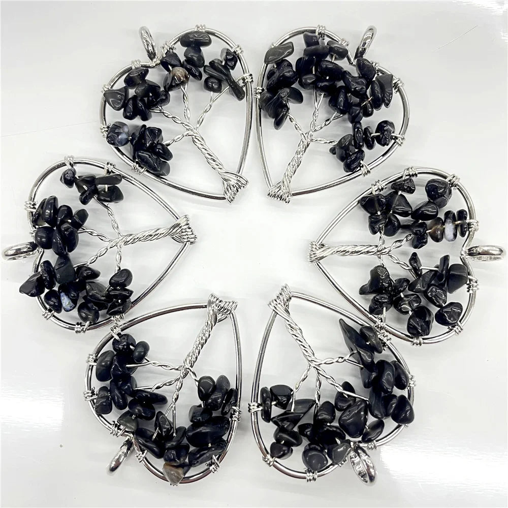 Set of six silver pendants with black stones on a white background