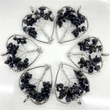 Set of six silver pendants with black stones on a white background