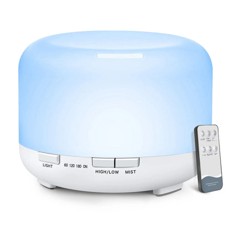 White humidifier with blue light and remote control on a white background