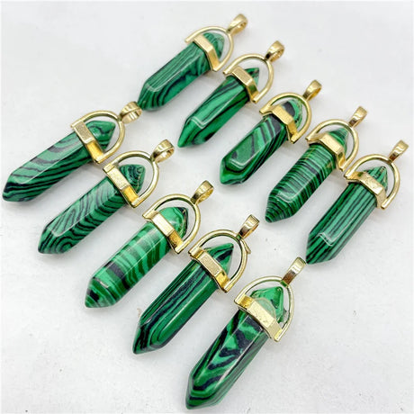 Green malachite pendants with gold accents on a white background