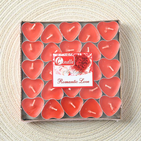 Box of heart-shaped candles with a decorative label on a textured surface