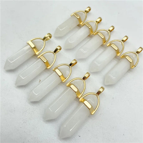 Set of crystal pendants with gold frames on a light gray background