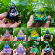 Collage of triangular crystal pyramids held in hands against a green leafy background