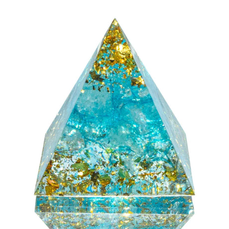 Pyramid-shaped crystal with blue and gold colors on a white background