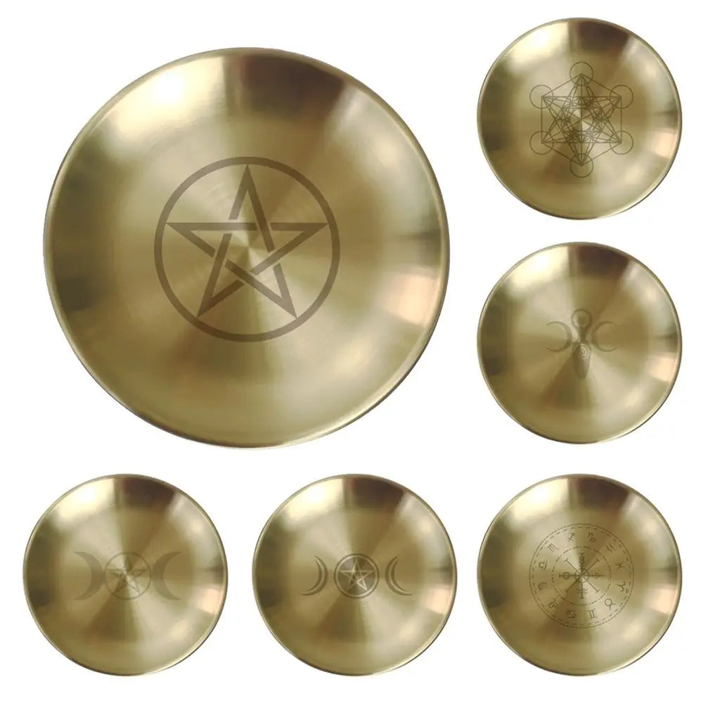 Set of six brass discs with engraved symbols on a white background