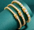 Gold bracelet with diamonds on a green background