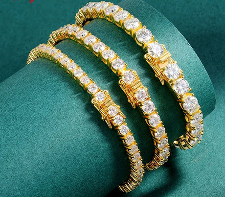 Gold bracelet with diamonds on a green background